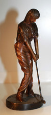 Sculpture femme golfeur en