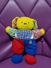 Doudou chien jaune rouge bleu vert SIMPSON TRADING abc grelot 20 Cm