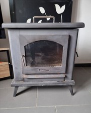 poêle à bois en fonte, gris d'occasion.  Ne prend pas beaucoup de place.