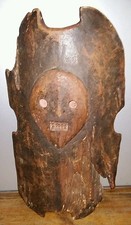 Bouclier art africain en bois avec tête sculptée 36,5 par 65 cm poignée monoxyle