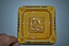 Beau cendrier ancien craquelé jaune or "Au Louvre PARIS"- Lion couché sur un "L"
