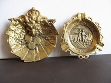 2 CENDRIERS PATINE BRONZE Décors en relief: tête de griffon, cartes et jetons.