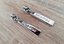 2 curseurs, en métal chromé, avec tirette de marque SCAPIN pour fermeture éclair