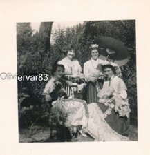 Vintage photo - 4 young women in folk dresses with sun umbrella in a garden