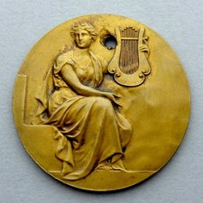 Woman dressed in antique style holding a lyre. Accordion. Belgian Antique Medal.