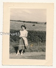 Vintage photo 1958 - elegant woman posing along a field