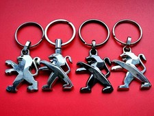 PEUGEOT LOT 4 PORTE CLES LOGO AUTOMOBILE LIONS tous différents ( 1 noir )