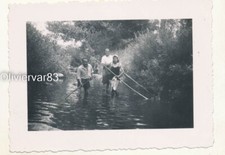 Vintage photo - woman in swimsuit and 2 men walking in a river