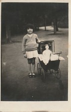 Photo fillette avec sa poupée dans landeau (9x13.5)