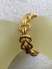 Bracelet doré NINA RICCI motif noeud en parfait état.