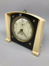 ancien réveil mécanique bicolore blanc et marron/ marque S M I en état de marche