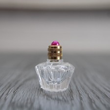 Miniature vide, bouteille en verre forme étoile décorée d'une perle
