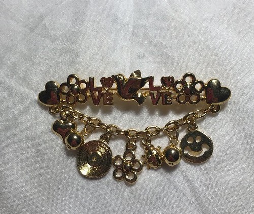 Gold tone love pin - tone,