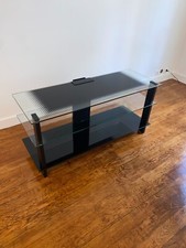 Meuble TV en verre et en acier, en très bon état. Prix négociable.