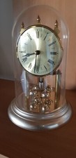 horloge à poser  Quartz à pendule rotatif, métal doré sous cloche Germany