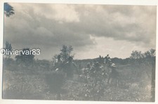 Vintage artistic photo - people in garden field under dark cloud sky