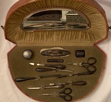 Antique dressing table set in original case full of items and a mirror.