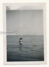 Vintage photo - 3 young women posing alone in the sea