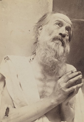 Portrait man praying by - of,