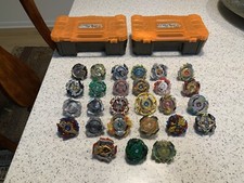 28 Beyblades & 2 carrying