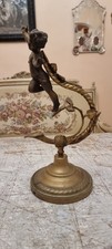 Impressive Bronze Cherub angel on the stand looks like swinging on the roses 
