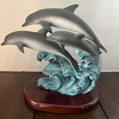 Pod dolphins surfing the - of,