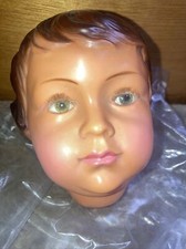 (i) tête de poupée