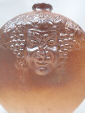 Ancien flacon / gourde en céramique à décor de 2 têtes du Dieu Bacchus / diable