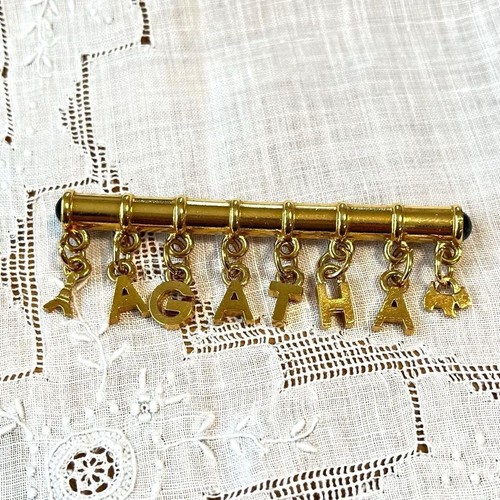Broche agatha logo doré avec - logo,