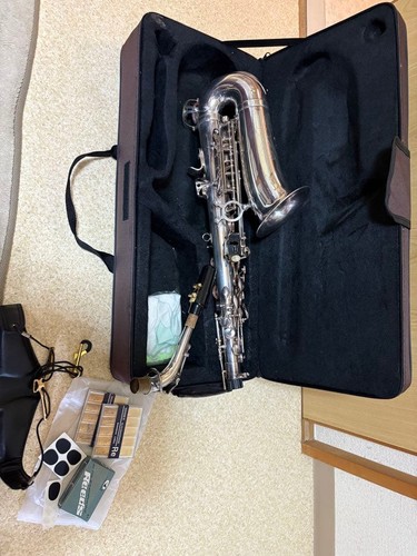 Silver saxophone with reed and