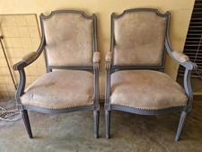 Paire de fauteuils de style Louis XVI en bois mouluré laqué gris et simili cuir