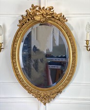 MIROIR / GLACE OVALE EPOQUE NAPOLEON III EN BOIS ET STUC DORÉ DE STYLE LOUIS XV
