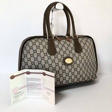 Sac à main Gucci GG Plus Supreme PVC beige et cuir doré