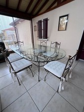 Table ovale Méréïde en verre biseauté sur support en fer forgé poli brossé