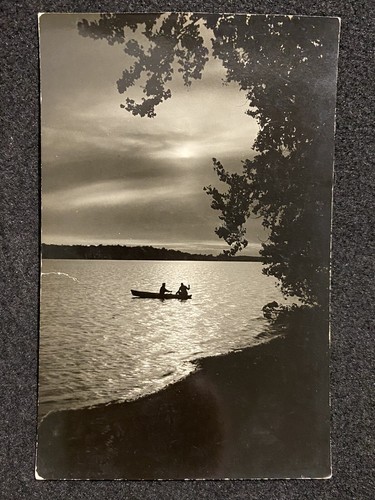 Men canoe night rppc - canoe, at