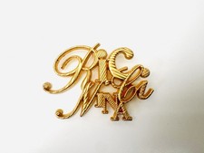 Broche logo  monogramme NINA RICCI vintage 1990s