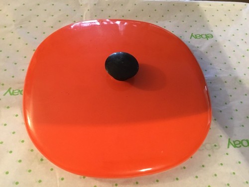 Large orange metal pot lid