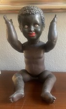 Ancien poupon noir en terre de