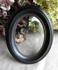 CADRE OVALE EN BOIS NOIRCI -