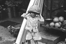 Vietnam 1971- Vietnamese Boy Putting On Army Headgear