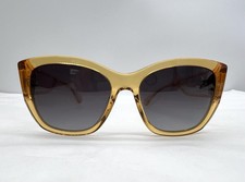 Lunettes de soleil Chanel avec des verres gris dégradés et la monture et les br