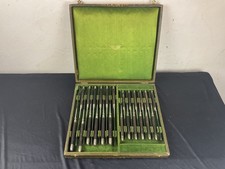 Christofle 24 couteaux Manche en ébène virole argent .