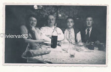 Vintage photo - 3 men and a woman at dining table with bottle of wine