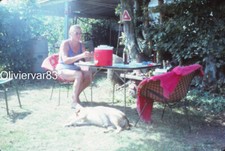 Vintage photo slide 1982 - woman in swimsuit by picnic table and dog