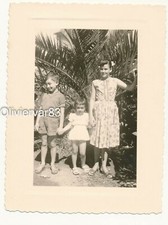 Vintage photo - young woman and children in palm tree garden