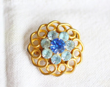 broche métal doré et pierres taillées bleues - diamètre 3 cm  - excellent état