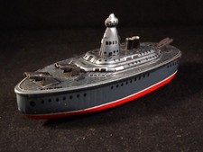 Ancien jouet bateau navire de guerre canon tôle lithographiée KK style penny toy