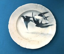 plat rond en faïence signé