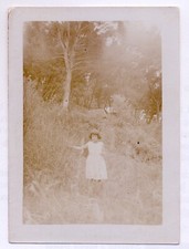 Vintage photo sepia - young girl in white dress in woods