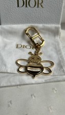 Porte clés Dior x KAWS doré état neuf